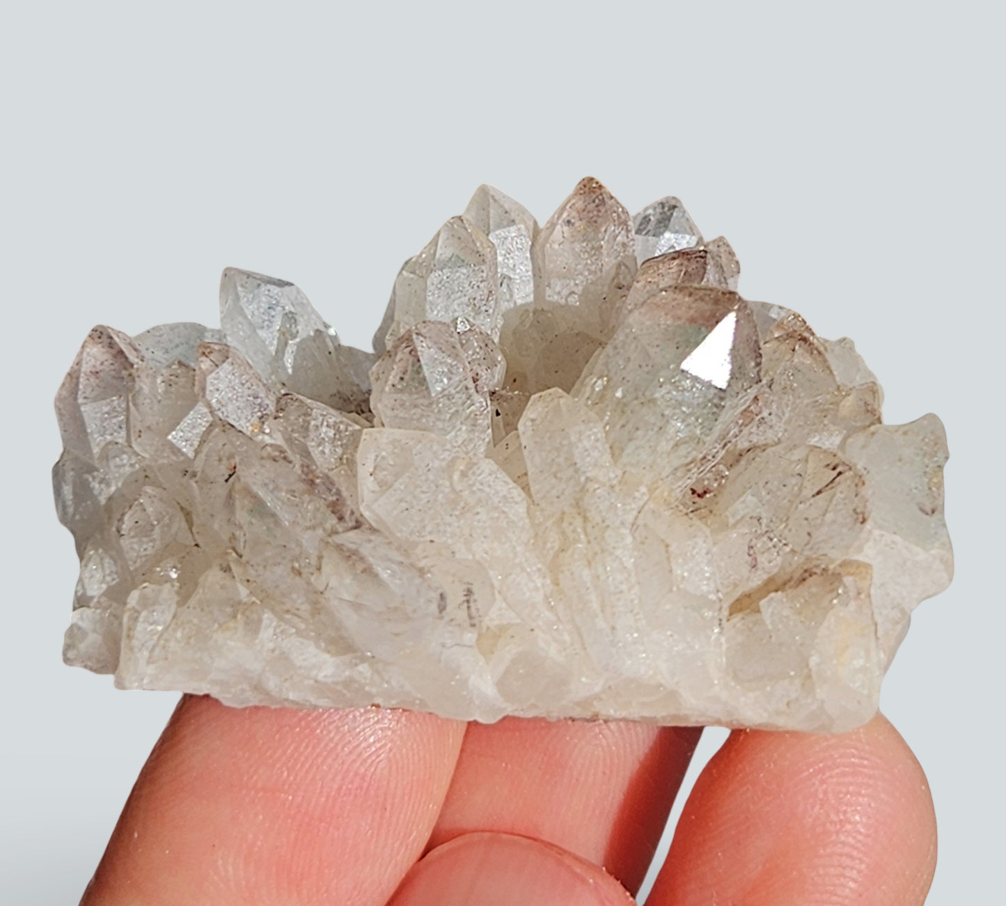 green phantom quartz cluster with hematite