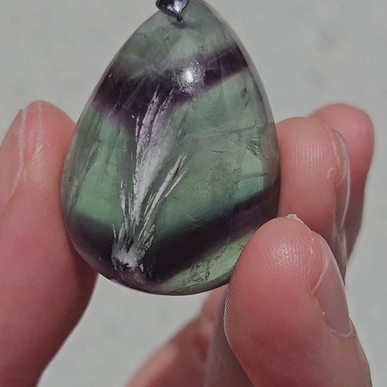 Video of rainbow fluorite pendant with white feathers
