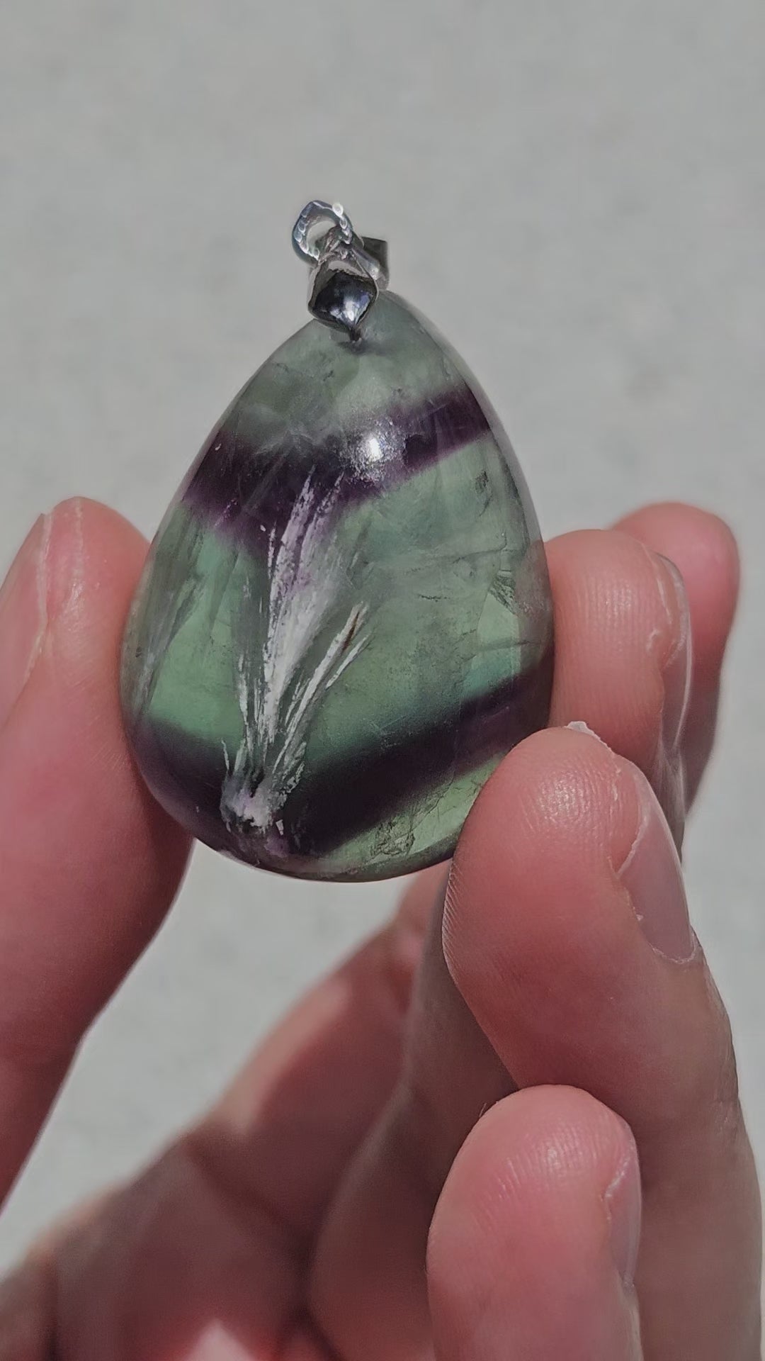 Video of rainbow fluorite pendant with white feathers